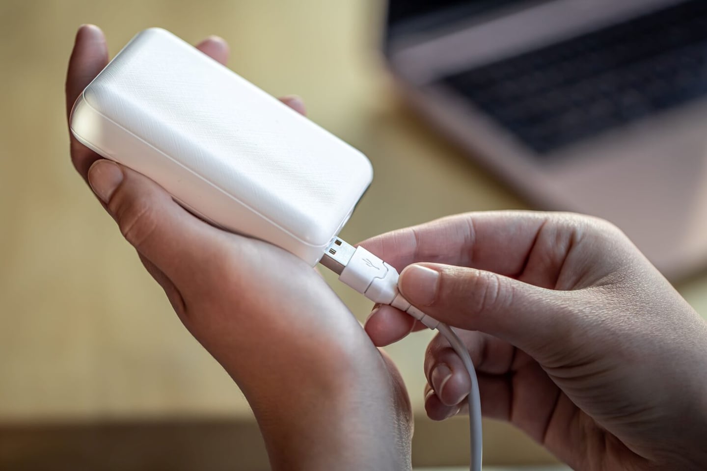woman-s-hand-holding-white-usb-cable-and-white-pow-2025-04-02-03-56-50-utc-1-1536x1024