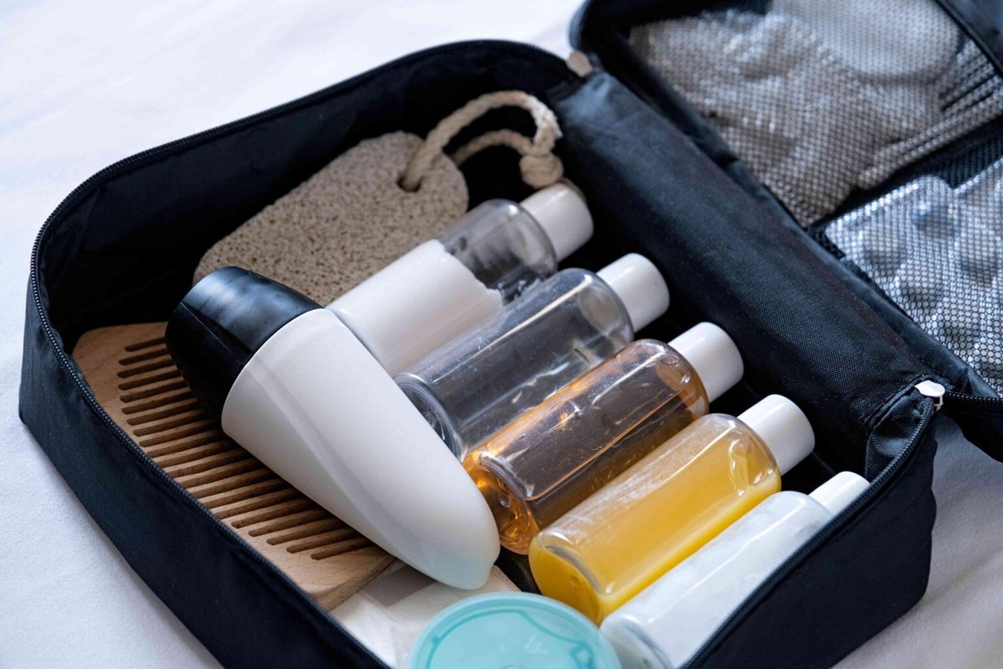 travel-cosmetics-kit-on-bed-top-view-2025-03-14-02-06-09-utc-1-1536x1024